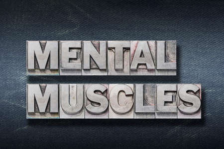 mental muscles phrase made from metallic letterpress on dark jeans backgroundの写真素材