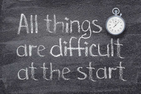 All things are difficult at the start Chinese proverb written on chalkboard with vintage precise stopwatchの写真素材
