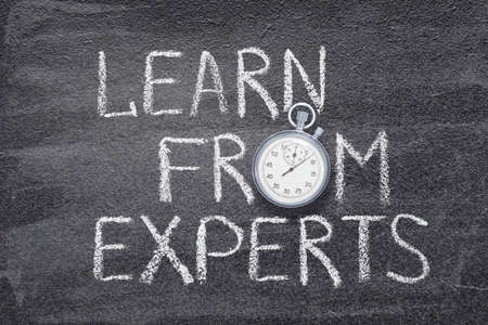 learn from experts phrase written on chalkboard with vintage precise stopwatchの写真素材