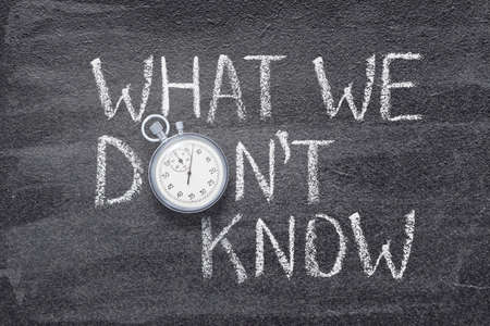 what we donât know phrase written on chalkboard with vintage precise stopwatchの写真素材