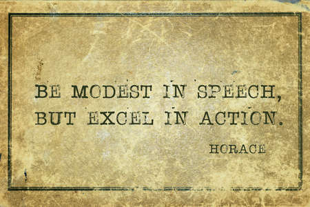 Be modest in speech, but excel in action -  ancient Roman poet Horace quote printed on grunge vintage cardboardの写真素材