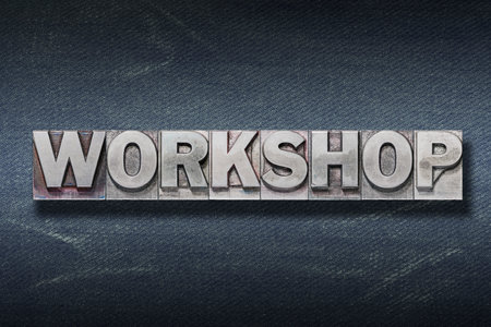 workshop word made from metallic letterpress on dark jeans backgroundの写真素材