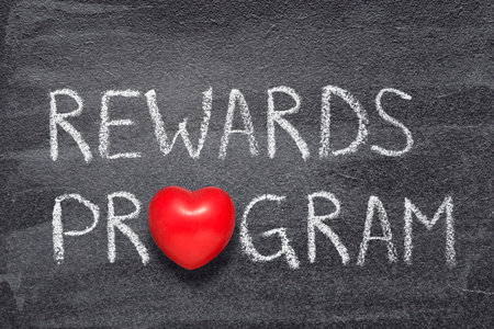 rewards program phrase written on chalkboard with red heart symbolの写真素材