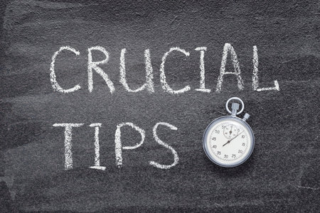 crucial tips phrase written on chalkboard with vintage precise stopwatchの写真素材