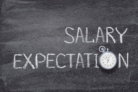 salary expectations phrase written on chalkboard with vintage precise stopwatchの写真素材