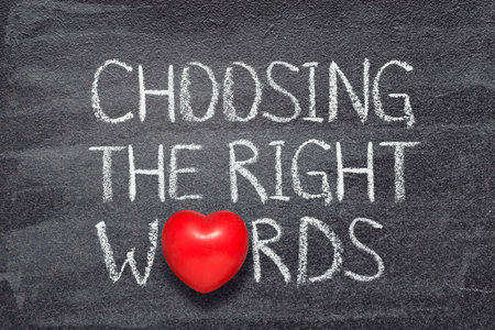 choosing right words phrase written on chalkboard with red heart symbolの写真素材