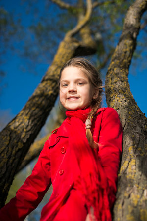 springtime portrait of girl between two willow treesの写真素材