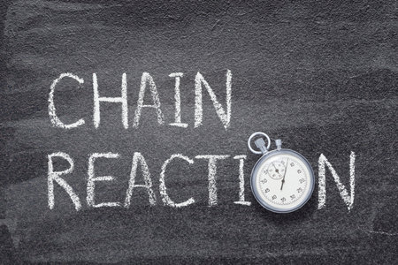 chain reaction phrase written on chalkboard with vintage stopwatch used instead of Oの写真素材