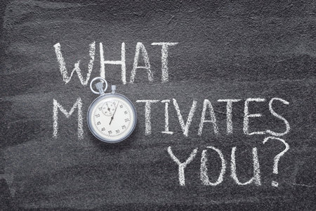 what motivates you question written on chalkboard with vintage precise stopwatchの写真素材