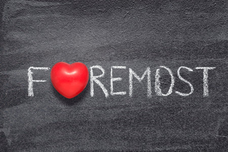 foremost word written on chalkboard with red heart symbolの写真素材