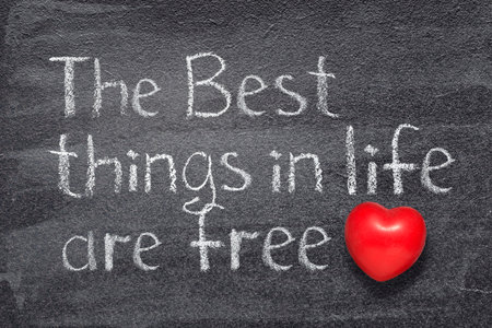 the Best things in life are free proverb written on chalkboard with red heart symbolの写真素材