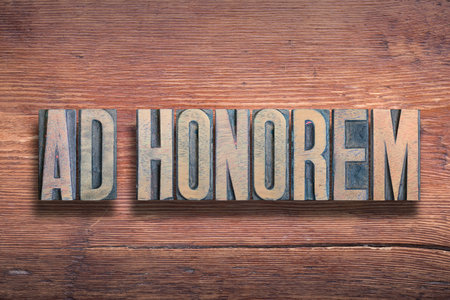 ad honorem ancient Latin saying meaning - to honor, combined on vintage varnished wooden surfaceの写真素材