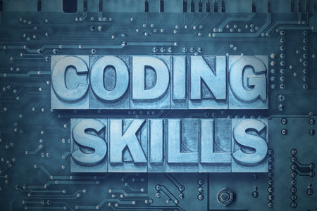 coding skills phrase made from metallic letterpress blocks on the pc board backgroundの写真素材