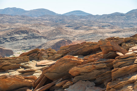 cracked slate rocks landscape by sunny day in Namibiaの写真素材