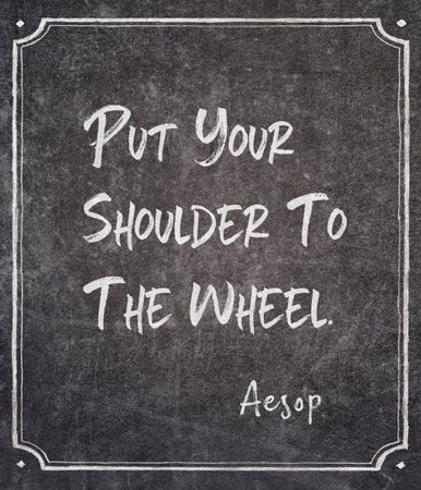 Put your shoulder to the wheel - famous ancient Greek story teller Aesop quote printed on framed chalkboardの写真素材