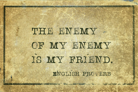 The enemy of my enemy is my friend - ancient English proverb printed on grunge vintage cardboardの写真素材