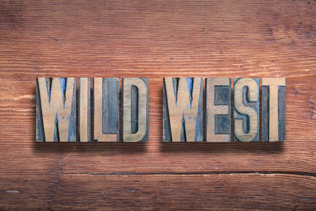 wild west phrase combined on vintage varnished wooden surfaceの写真素材