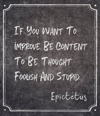 If you want to improve, be content to be thought foolish and stupid - ancient Greek philosopher Epictetus quote written on framed chalkboardの写真素材
