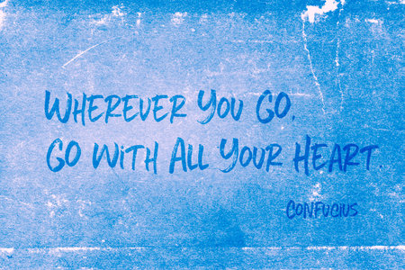 Wherever you go, go with all your heart - ancient Chinese philosopher Confucius quote printed on grunge blue paperの写真素材