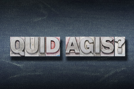 quid agis (whatâs up) question made from metallic letterpress on dark jeans backgroundの写真素材