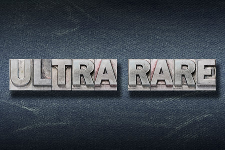 ultra rare phrase made from metallic letterpress on dark jeans backgroundの写真素材