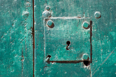 detailed background of green metallic door with focus on keyholeの写真素材