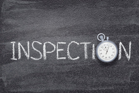 inspection word written on chalkboard with vintage precise stopwatchの写真素材