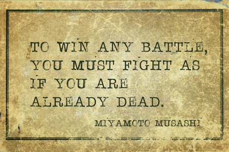 To win any battle, you must fight as if you are already dead - ancient Japanese swordsman and ronin Miyamoto Musashi quote printed on grunge vintage cardboardの写真素材