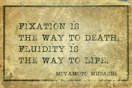 Fixation is the way to death. Fluidity is the way to life - ancient Japanese swordsman and ronin Miyamoto Musashi quote printed on grunge vintage cardboardの写真素材