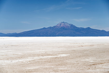 daytime landscape of famous Tunupa volcano behind Salar de Uyuni salts in Boliviaの写真素材