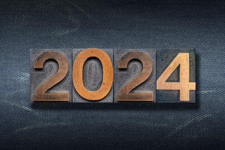 numbers 2024 made from wooden letterpress on dark jeans backgroundの写真素材