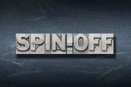 spin-off word made from metallic letterpress on dark jeans backgroundの写真素材