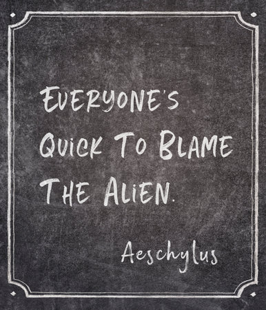 Everyone's quick to blame the alien - ancient Greek tragedian writer Aeschylus quote written on framed chalkboardの写真素材