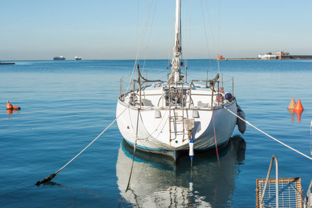 sailing yacht parked near pier in calm sea watersの写真素材