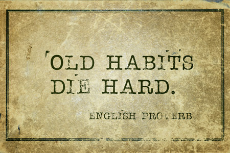 Old habits die hard - ancient English proverb printed on grunge vintage cardboard
