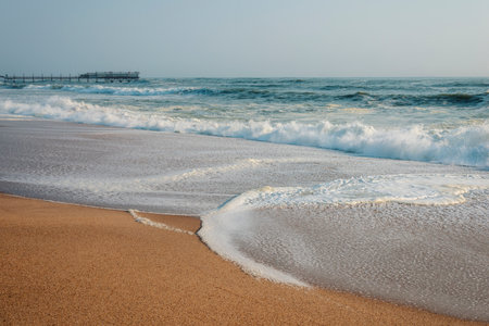 empty sand beach with distant pier in Swakopmund, Namibiaの写真素材