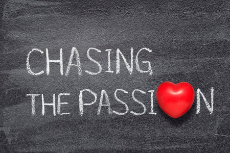 chasing the passion phrase written on chalkboard with red heart symbol