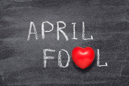 april fool phrase written on chalkboard with red heart symbolの写真素材