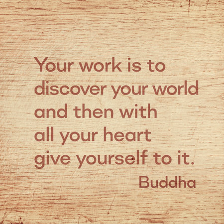 Your work is to discover your world and then with all your heart give yourself to it - famous quote of Gautama Buddha printed on grunge wooden boardの写真素材