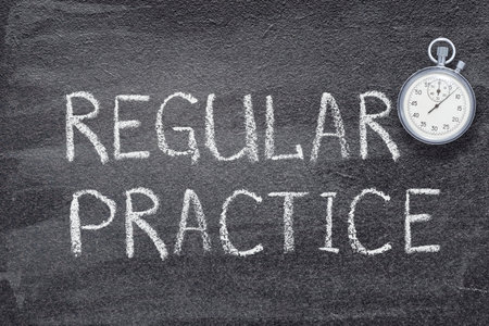 regular practice phrase written on chalkboard with vintage precise stopwatchの写真素材
