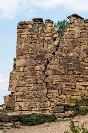 ancient cracked ruins wall at Gamsutl ghost town site in Dagestan, Russiaの写真素材