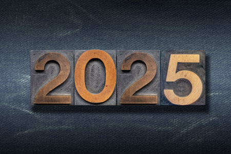 2025 numbers made from wooden letterpress on dark jeans backgroundの写真素材