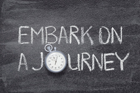 embark on a journey phrase written on chalkboard with vintage precise stopwatchの写真素材