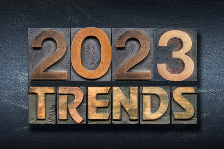 trends 2023 phrase made from wooden letterpress on dark jeans backgroundの写真素材