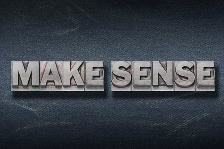make sense phrase made from metallic letterpress on dark jeans backgroundの写真素材