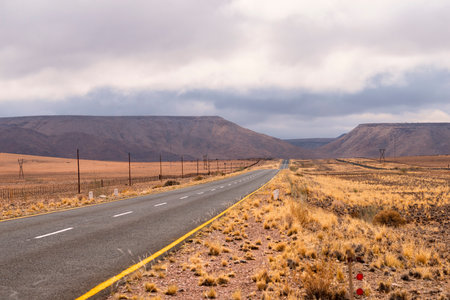 empty highway in desert of Namibia by gloomy dayの写真素材