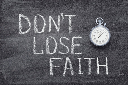 do not lose faith phrase written on chalkboard with vintage precise stopwatch