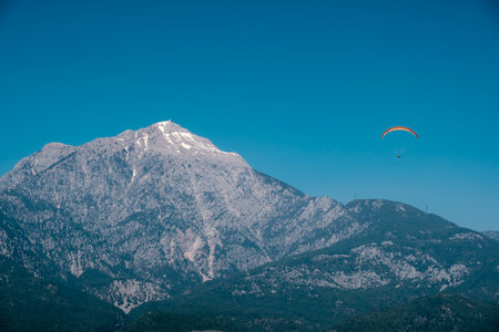 scenic Mount Tahtali landscape with flying paraglide by sunny day in Antalya Province, Turkeyの写真素材