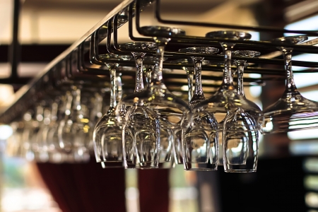 Glasses for wine above a bar rackの写真素材