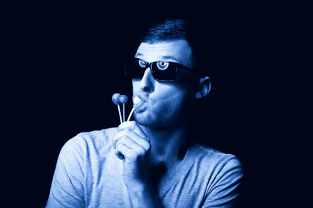 Mad man satisfies his passion to sweet lollipopsの写真素材